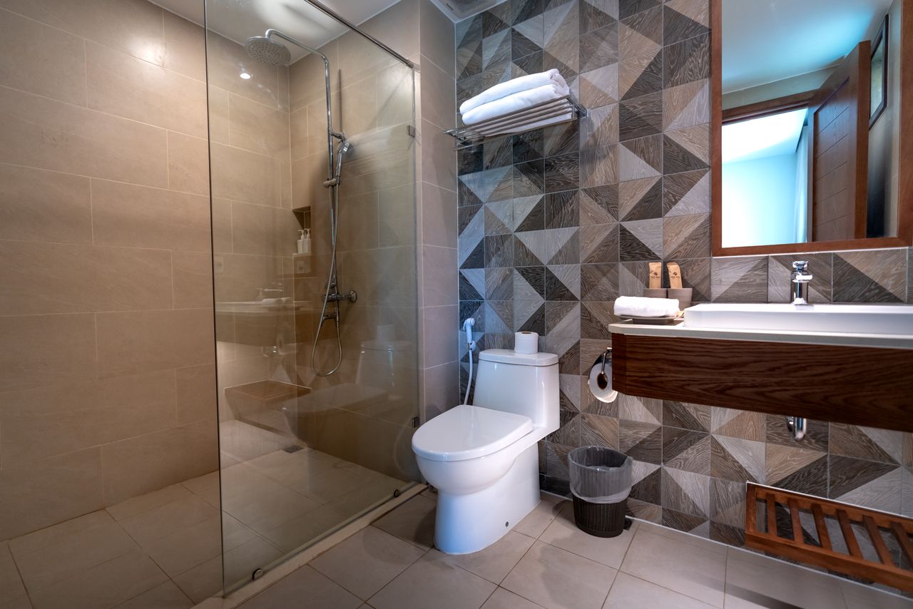 Elegant bathroom interior with a glass shower and stylish decor.